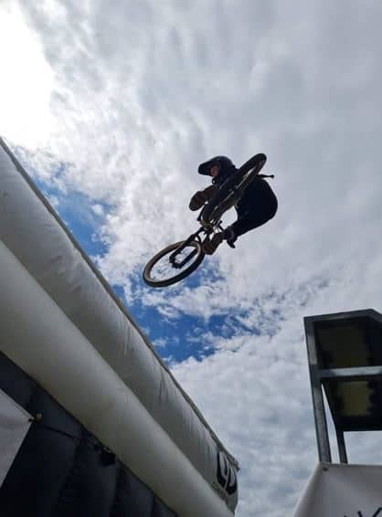 women jumping on a gap while riding a bike